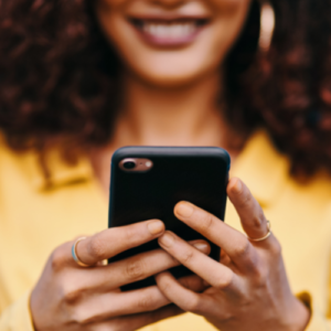 Black female smiling with cell phone